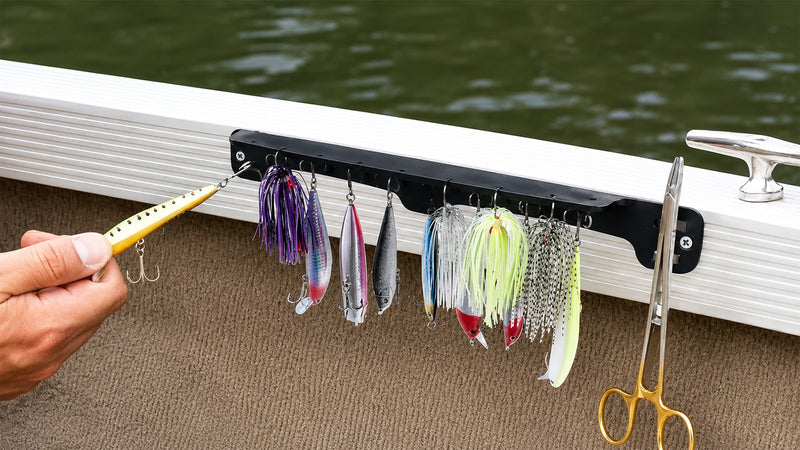 Supplier application photograph of the Long magnetic tackle rack mounted on a boat with example lures and scissors.