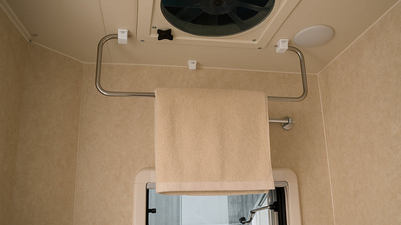 Ceiling-Mounted Folding Clothes Drying Rack for RV & Camper Laundry Storage — company-source example of use; other pictured objects are not included