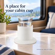 Illustrative use of the white TPE holder with a drinking glass seated inside; glass and tabletop are not included