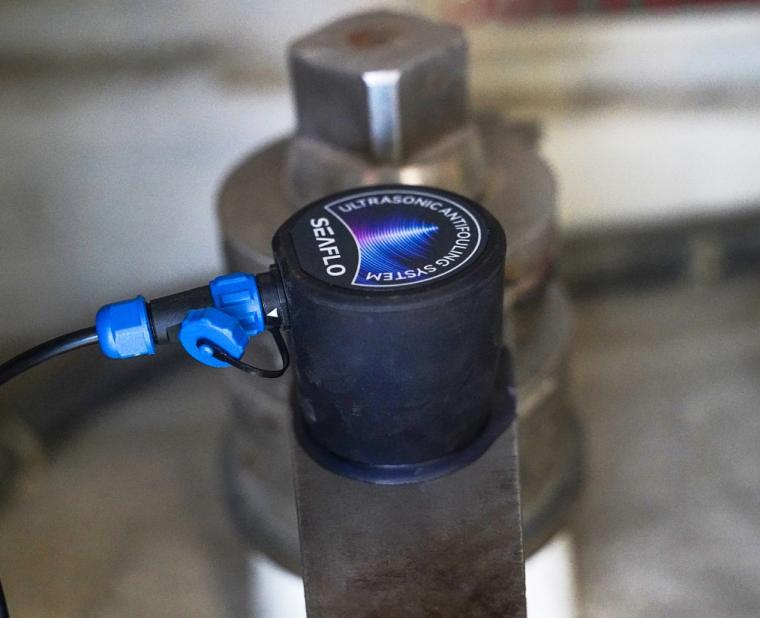 Manufacturer installation example: transducer bonded to a metal drive mounting surface with its blue signal connector attached